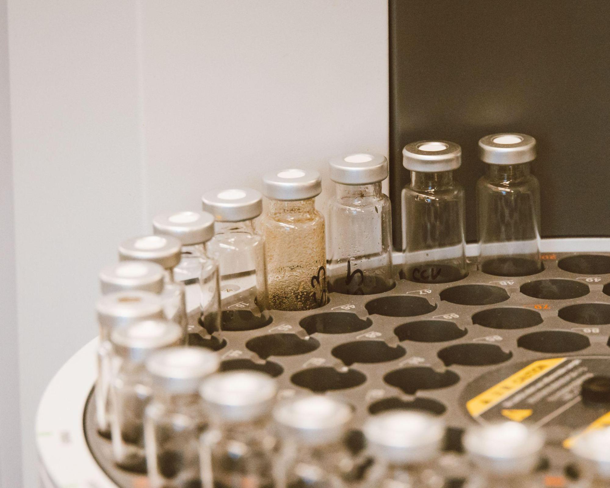 Glass vials arranged on machine, courtesy of Jess Loiterton